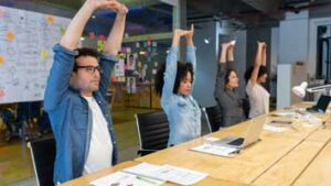 Workers stretching in a meeting